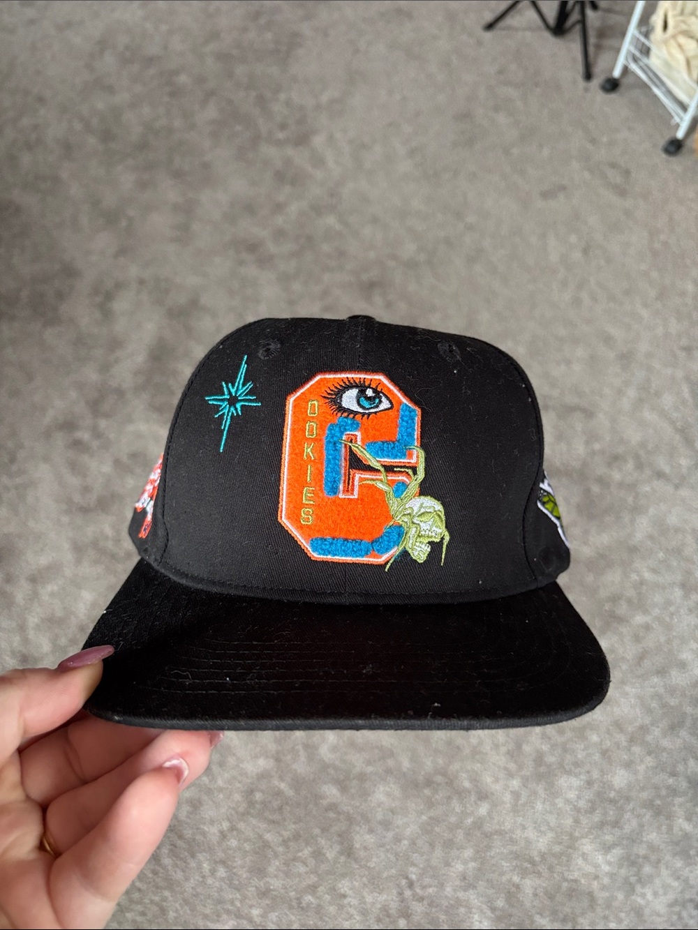Black Embroidered Snapback Hat with Colorful 'O' Patch